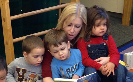 children and staff reading
