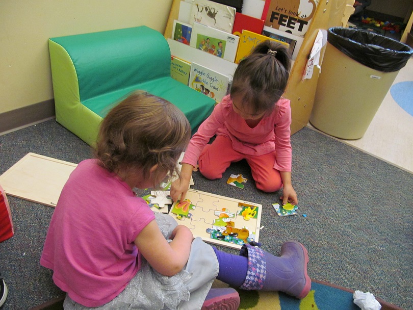 children doing a puzzle